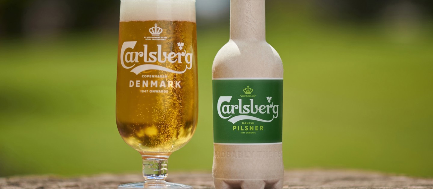 Green fibre bottle on wood surface